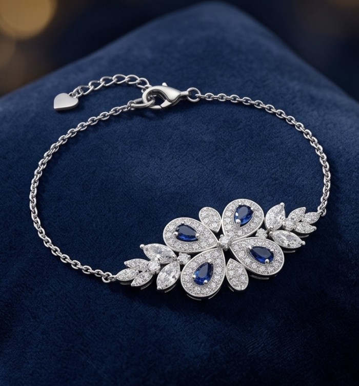 Precious Art deco Genuine 0.7 carat Sapphire .925 Sterling Silver handcrafted Bracelet - Art deco bracelet with sapphire stones on blue fabric, side view.