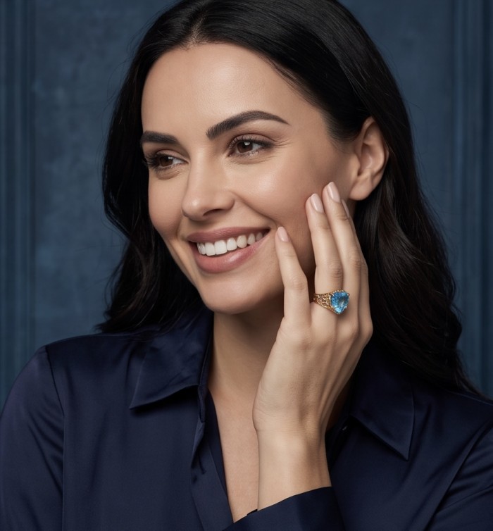 Blue Angel's Heart Natural heart cut 12.2 carat Swiss Blue Topaz Enamel .925 Sterling Silver dipped in 22K Gold handmade Statement Ring size 7 - Woman wearing Blue Angel's Heart ring, showcasing stone on hand.