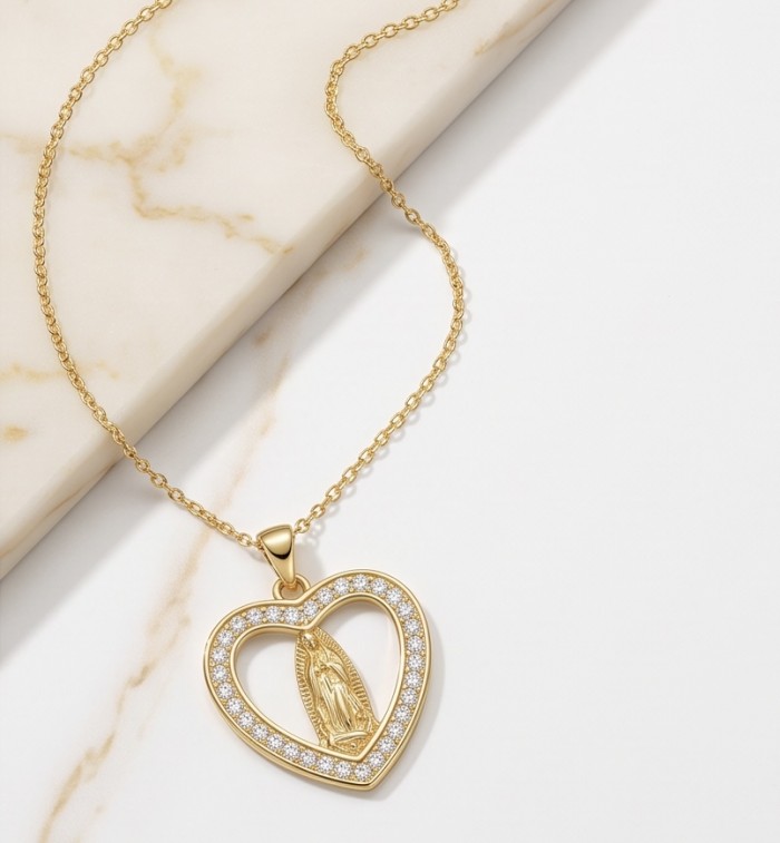 Holy Mary - Vintage design - 10K Gold over 925 Sterling Silver handcrafted Necklace - Gold heart pendant with Mary, top view on marble background