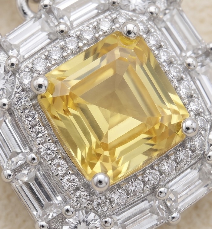 Art Deco - Luxurious asscher cut 7.5 carat Yellow Sapphire .925 Sterling Silver handcrafted earrings - Close-up of asscher-cut yellow sapphire with diamond accents.