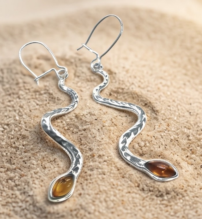 SEAHORSE Style genuine green Baltic Amber .925 Sterling Silver earrings - Snake-shaped earrings with amber stones on sandy surface, top view.
