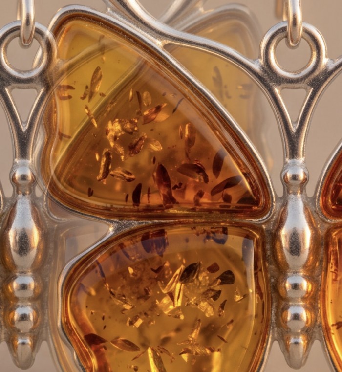 Golden Butterflies carved Baltic Polish Amber .925 Sterling Silver earrings - Close-up of amber butterfly pendant with sterling silver detailing