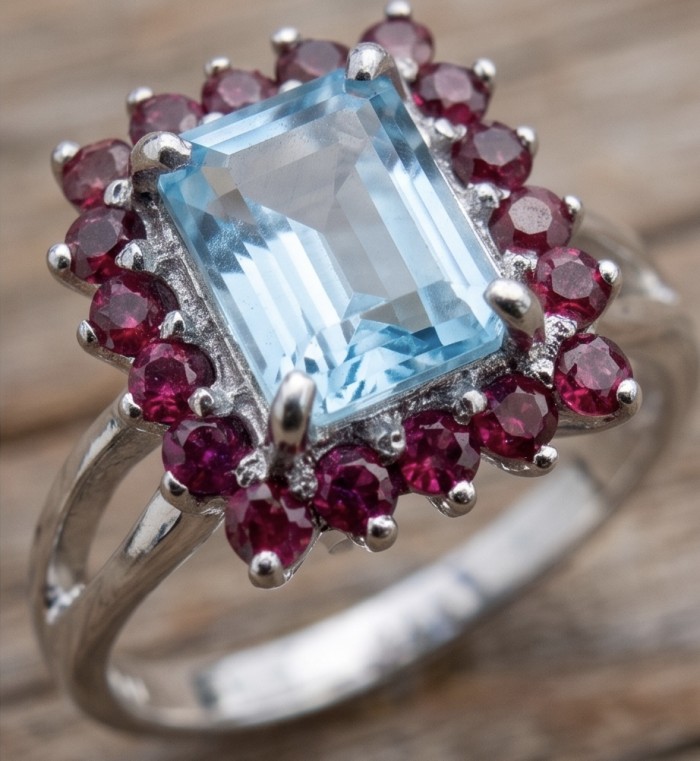 Atlantica 5.8 carat Swiss Blue Topaz .925 Sterling Silver dipped in rhodium handcrafted ring size 9 - Close-up of Swiss Blue Topaz ring with red accents on sterling silver.