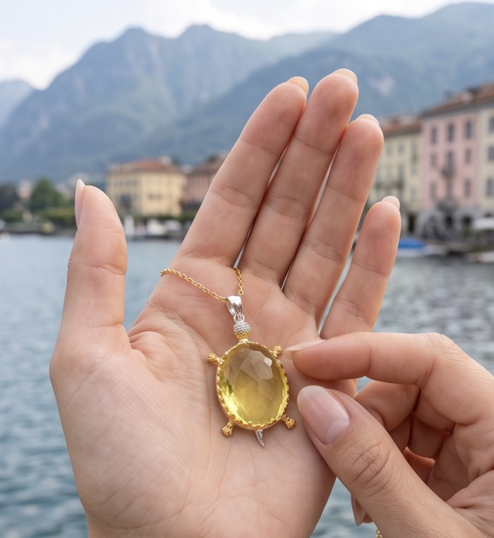 Precious Turtle Authentic 24.2 carat Brazilian Citrine rhodium over .925 Sterling Silver handcrafted Statement Pendant - Close-up of turtle-shaped citrine pendant held in hand by a lake.