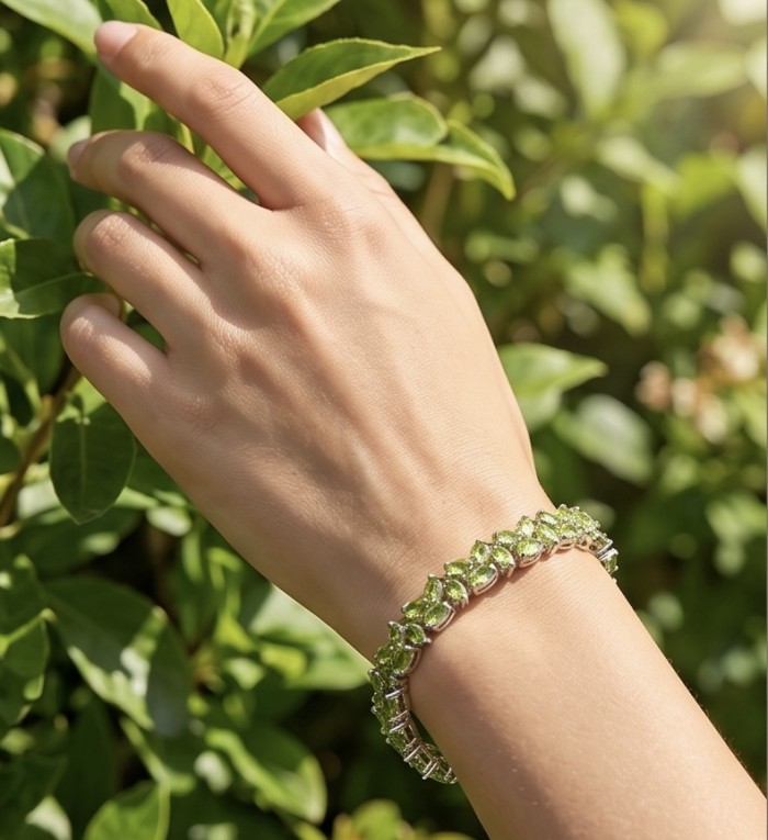 Melissa - Great Masterpiece 52.2 carat genuine Peridot .925 Sterling Silver handmade Statement bracelet - Peridot bracelet worn on hand with greenery background