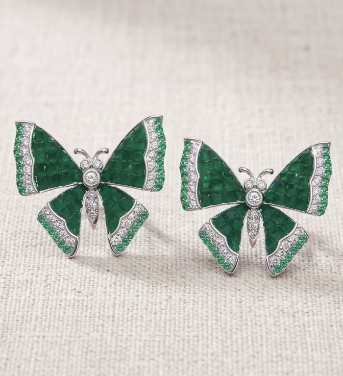 Incredible green Butterflies genuine mystery setting 11.5 CARAT Emerald .925 Sterling Silver handcrafted Earrings - Butterfly earrings with green stones, front view on textured fabric.