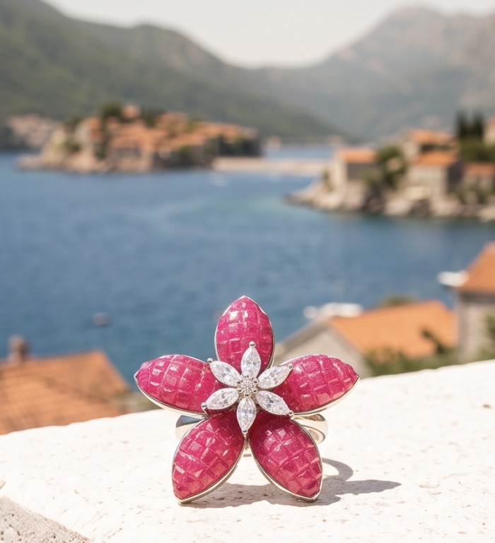 Scarlett mystery setting 9.7 ctw Mozambique Ruby .925 Sterling Silver dipped in rhodium handcrafted Statement Ring size 6 - Close-up of ruby flower ring with scenic background.