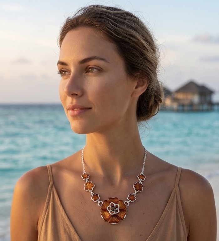 Floral design - natural Golden carved Baltic Amber .925 Sterling Silver handcrafted necklace - Golden carved Baltic Amber necklace worn at the beach, side view.