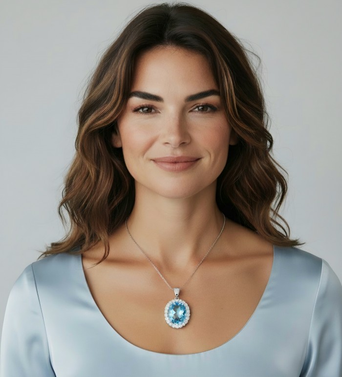 Tiffany Incredible oval cut 45.4 carat Swiss Blue Topaz rhodium over .925 Sterling Silver handcrafted pendant - Woman wearing oval Swiss Blue Topaz necklace, frontal view