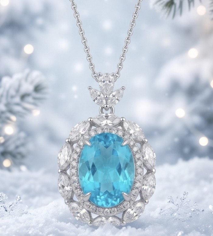 Brazilian's Briliance - oval cut 24.7 carat Paraiba Tourmaline .925 Sterling Silver handcrafted necklace - Close-up of oval cut 24.7 carat Paraiba Tourmal necklace on snowy background