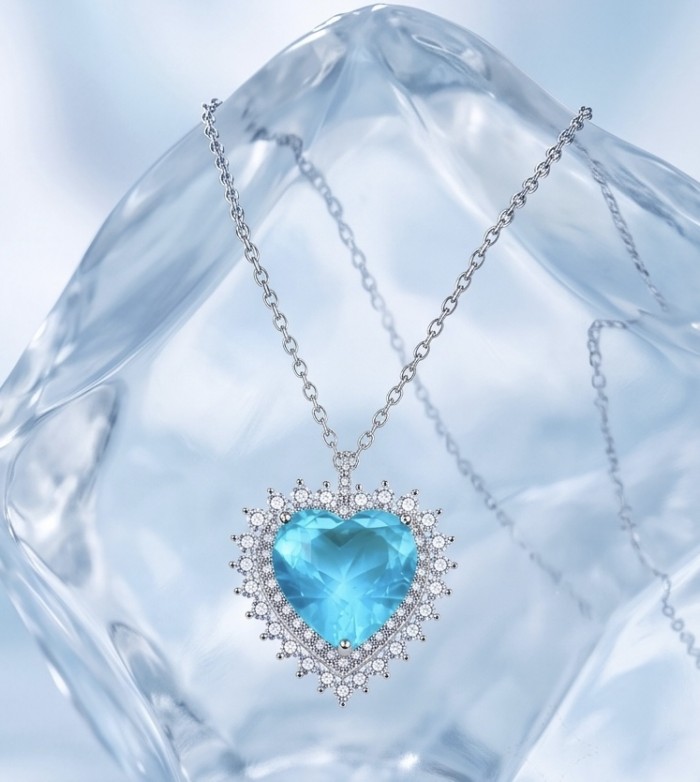 Endless Love 10.5 carat Swiss Blue Topaz .925 Sterling Silver Handcrafted necklace - Heart-shaped blue topaz necklace on crystal background, front view.