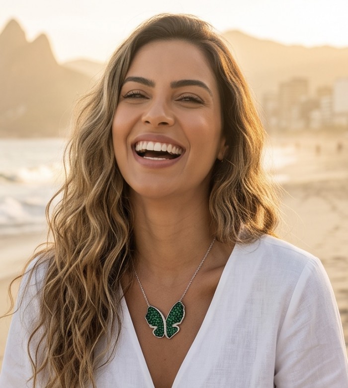 Precious Butterfly authentic 22.9 carat Colombian Emerald .925 Sterling Silver handcrafted Statement necklace - Woman wearing Precious Butterfly necklace on beach background.