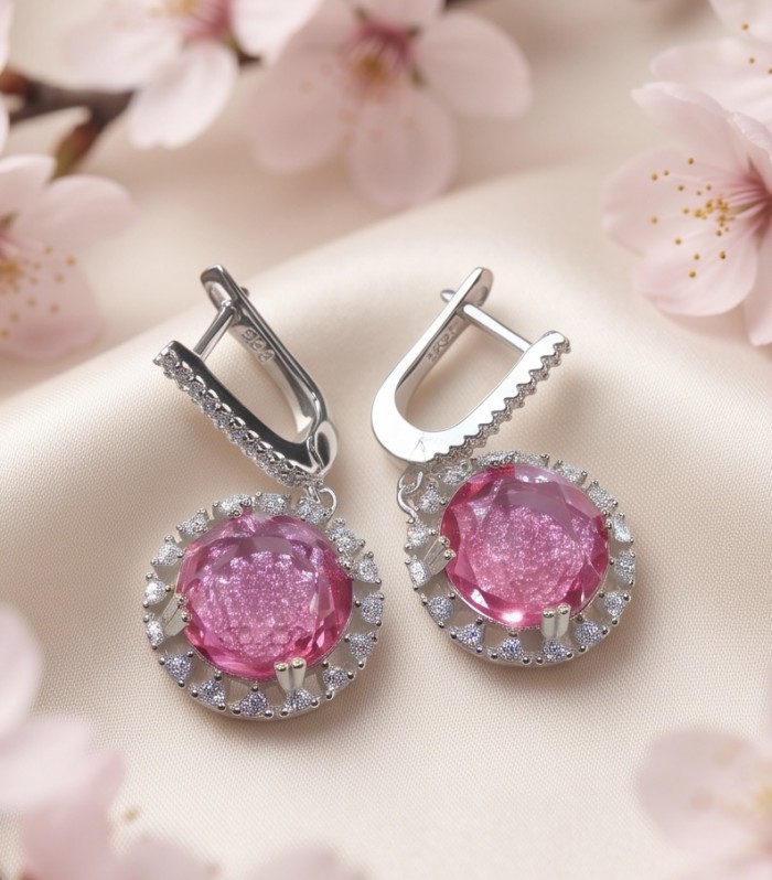 Tiffany - authentic 12.7 carat Pink Sapphire .925 Sterling Silver handcrafted Earrings - Pink sapphire earrings on satin with floral background, front view.