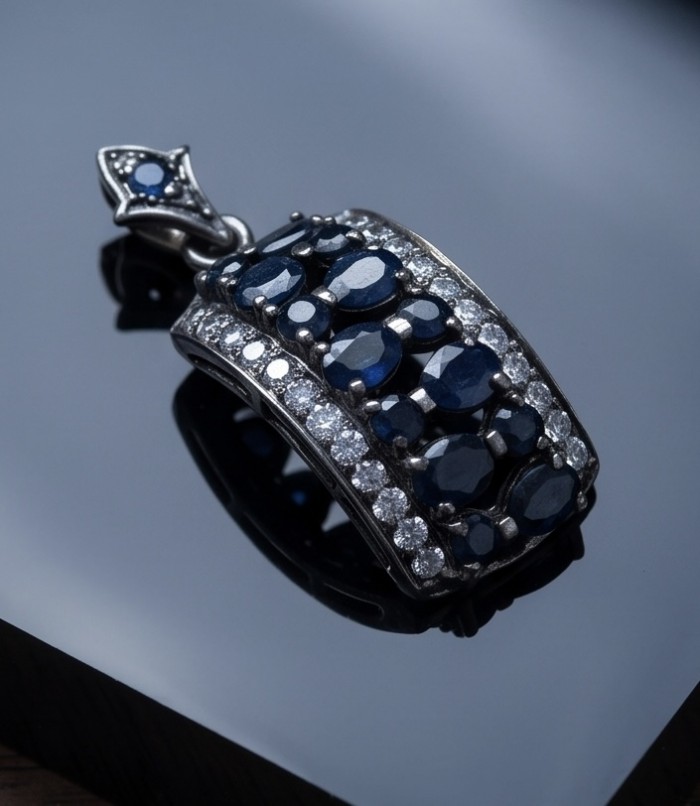 Vintage Beauty 9.7 carat Mozambique Sapphire Black Rhodium over .925 Sterling Silver handcrafted pendant - Close-up of Vintage Beauty sapphire pendant on black surface
