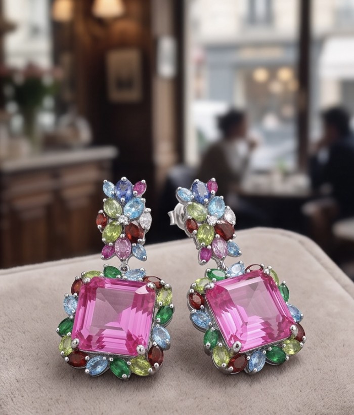 Large - Tiffany - authentic 41.5 carat Pink Sapphire rhodium over .925 Sterling Silver handcrafted Statement Earrings - Close-up of colorful earrings with large pink sapphire in a cafe setting