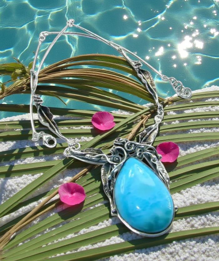 Glorious Nature Best quality authentic 47.5 carat Larimar . 925 Sterling Silver handmade necklace - Larimar necklace on palm leaves with pool in background, top view.