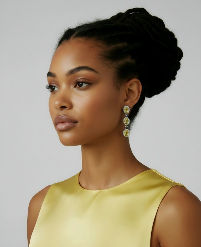 Luxurious - 24.4 carat Yellow Sapphire from Ceylon .925 Sterling Silver dipped in Rhodium handcrafted earrings - Side view of yellow sapphire earrings worn by a model
