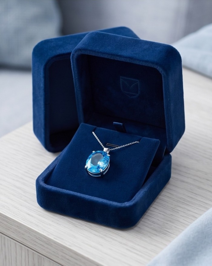 Vintage style 20.8 carat Swiss Blue Topaz .925 Sterling Silver DIPPED IN RHODIUM handmade Pendant - Blue topaz pendant in box, top view, showcasing the gemstone.