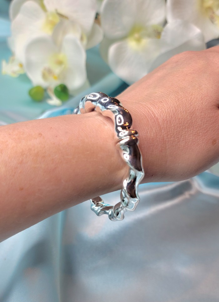 Fancy .925 Sterling Silver handcrafted Statement Italy made Bracelet - Sterling silver bracelet worn on wrist, close-up view, flower background.